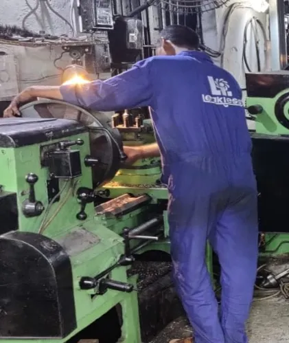 Machinist turning a pump casing on a lathe in the Leakless works